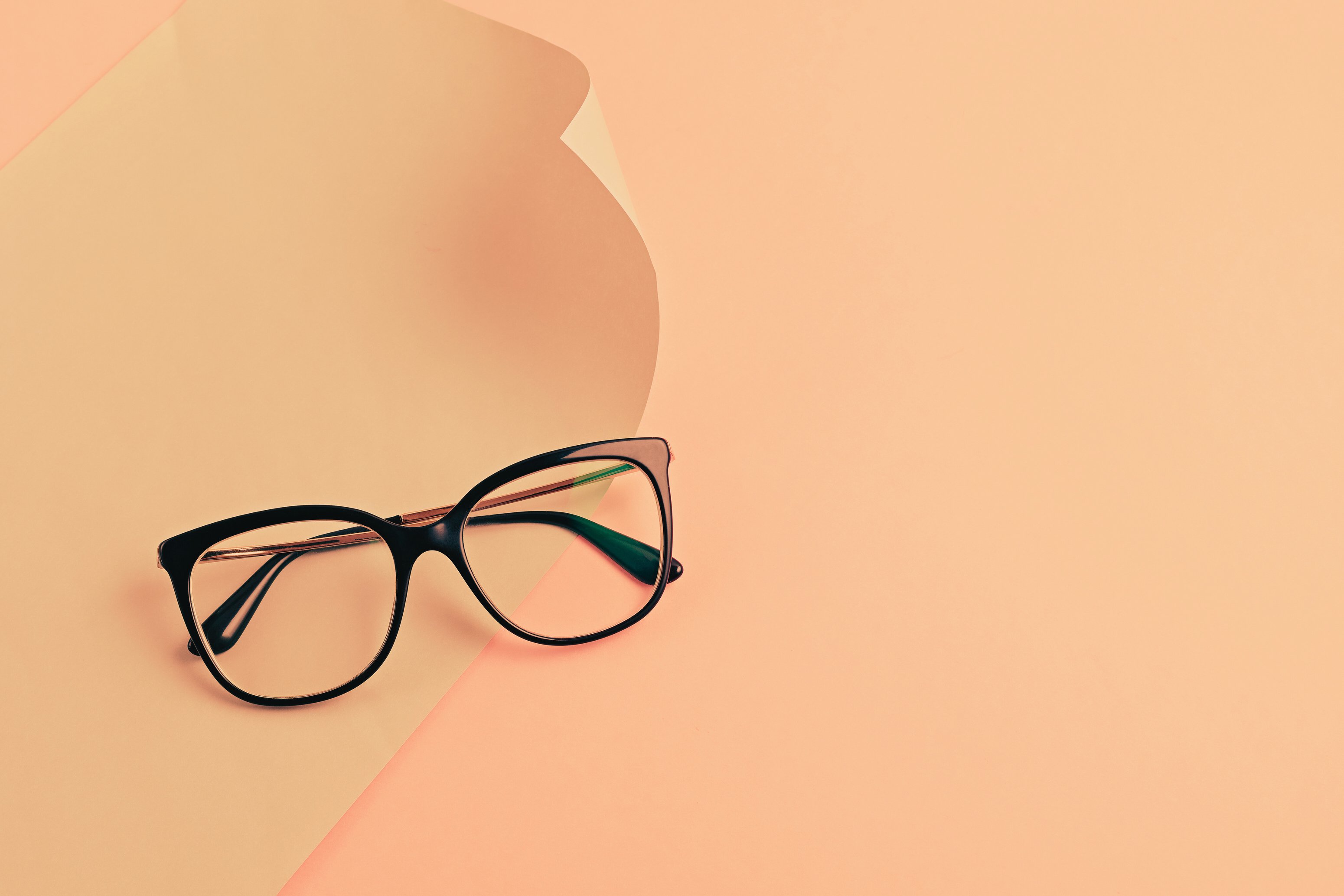 a pair of glasses on a pink background